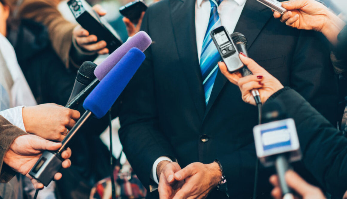 Journalists interviewing businessman.