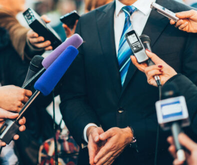 Journalists interviewing businessman.